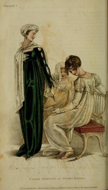 A colored fashion plate depicting three women in ladies’ evening dress: the first, left, standing, wears a green velvet empire waist gown with cut sleeves to reveal white fabric beneath; the second, middle, seated, wears a yellow empire waist dress with a white bodice; the third, right, seated, wears a white empire waist dress with a train and puff sleeves.